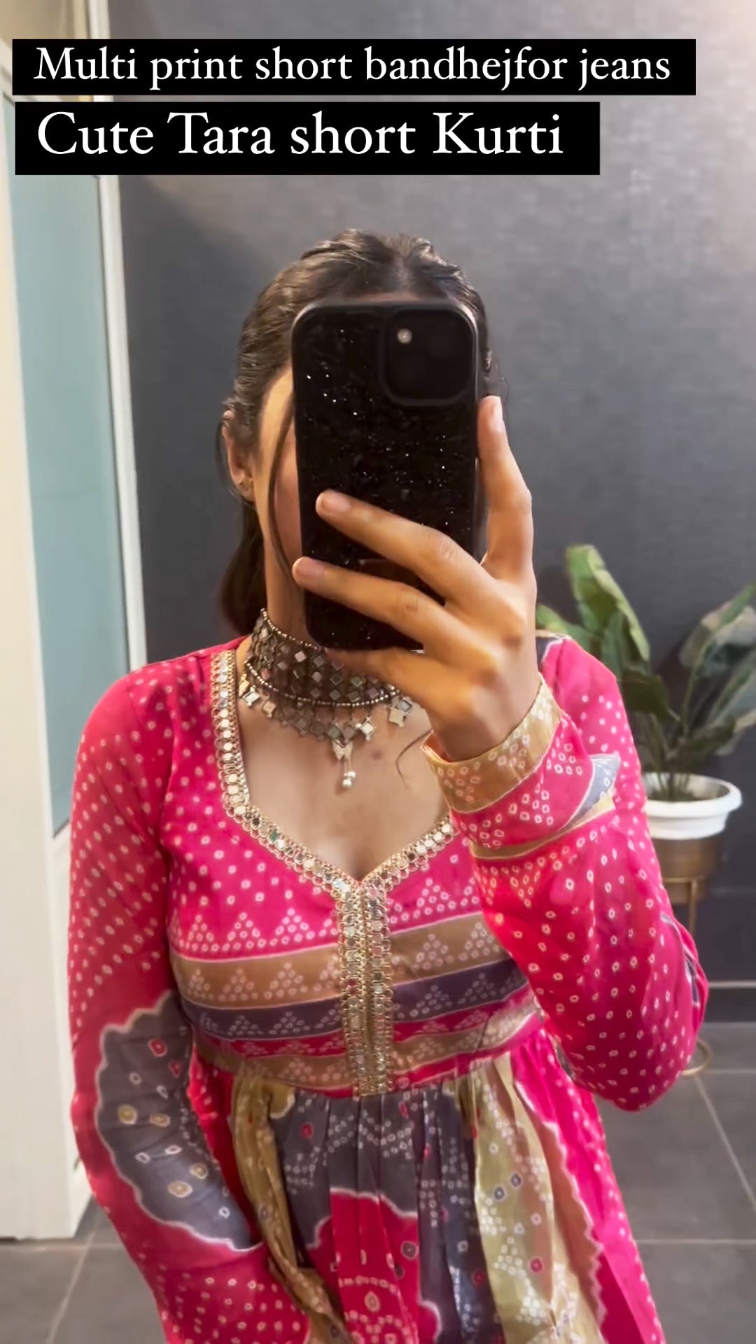 Woman wearing multi print bandhej Tara style short kurti with jeans