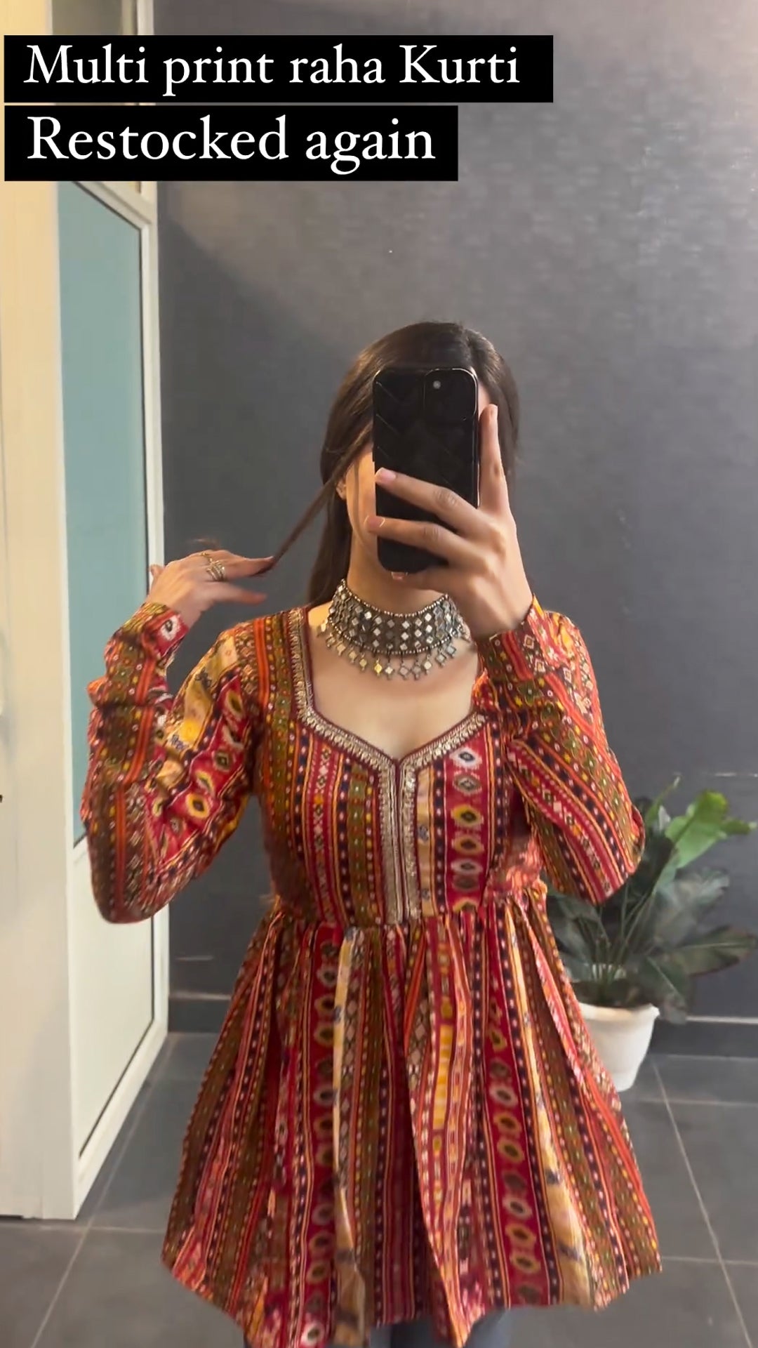 Woman wearing multi print short kurti with jeans