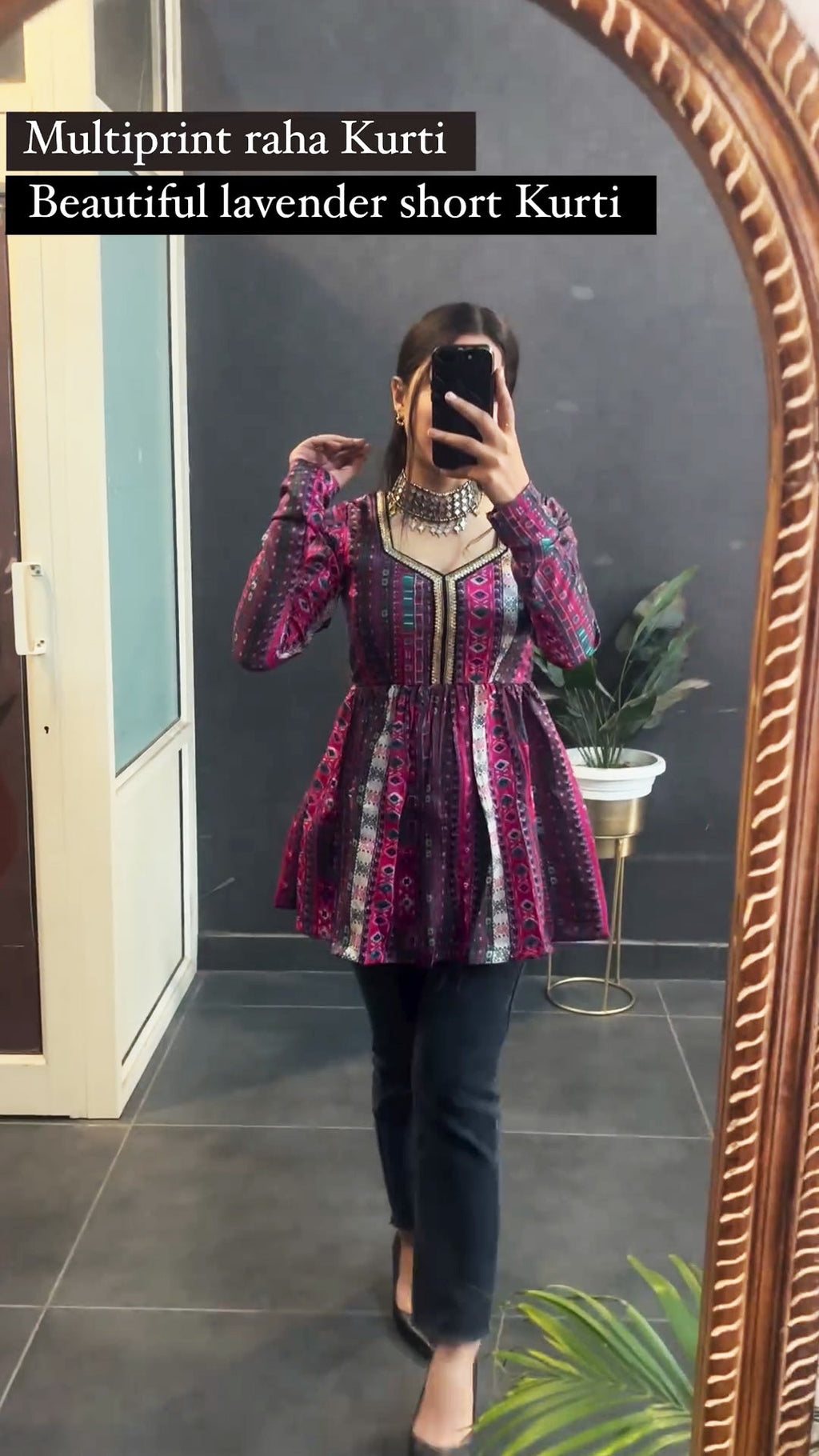 Woman wearing lavender multi print short kurti with leggings