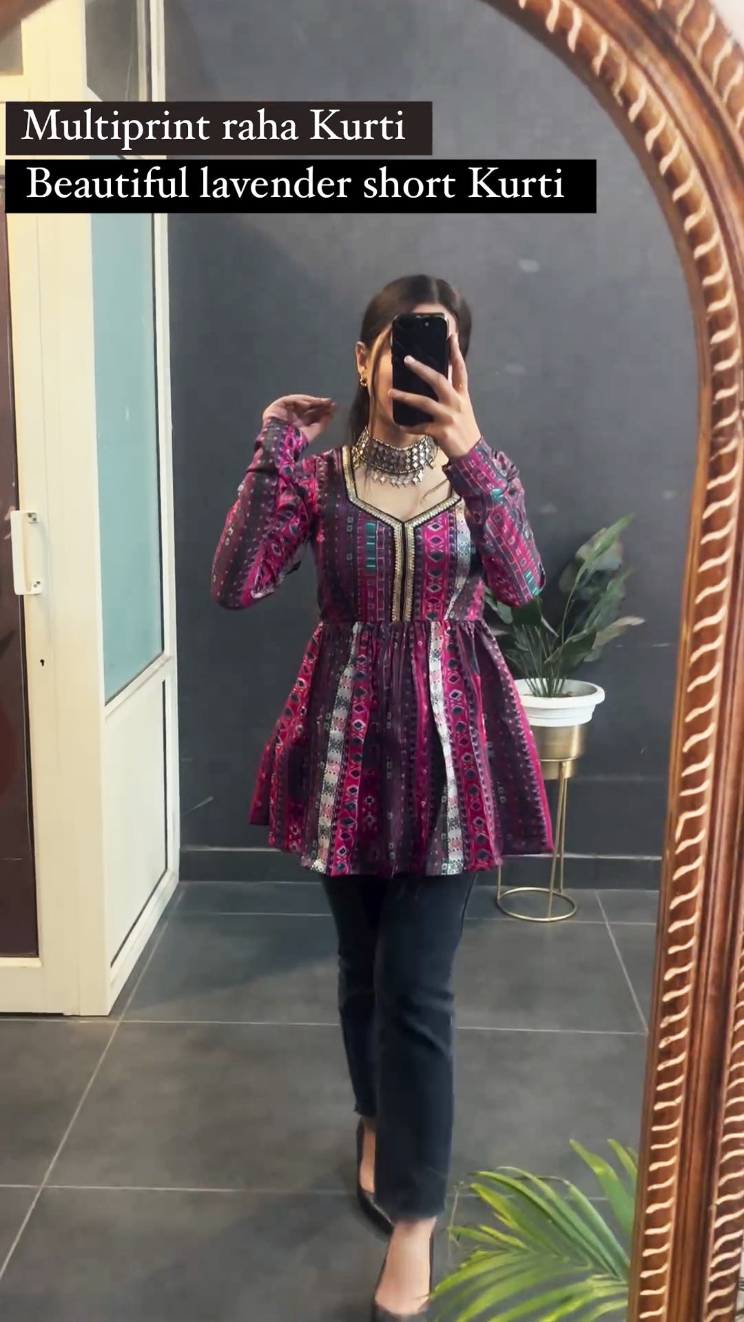 Woman wearing lavender multi print short kurti with leggings